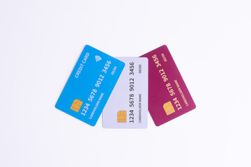 Three Fictional Cards Blue, White, Red on White Background. Representing diverse banking options, financial services, and secure digital payment.
