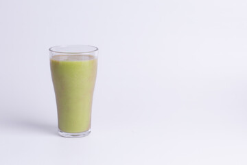 Glass of Fresh Avocado Juice Isolated on White Background with Copy Space. Minimalist composition for healthy eating, detox program, or summer drink menu promotion.
