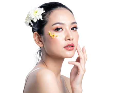 Asian woman with flowers in hair and on face, posing with soft light, against a dark, transparent background