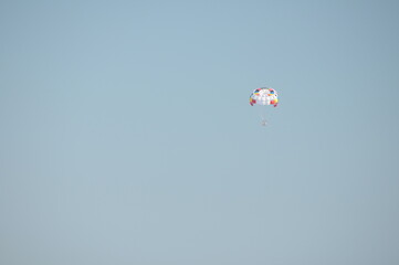 Colorful parasailing adventure over blue ocean water