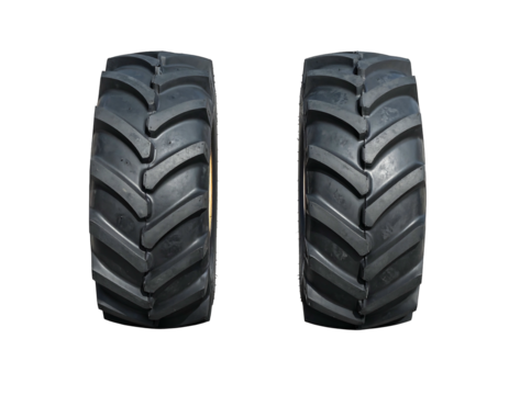 Close-up of two new, clean tractor tires against a stark black background, showcasing their deep, detailed treads