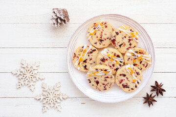 Christmas holiday cranberry orange icebox cookies. Above view table scene on a white wood background.