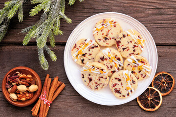 Naklejka na ściany i meble Christmas holiday cranberry orange icebox cookies. Top down view table scene on a dark wood background. Naklejka na ściany i meble Christmas holiday cranberry orange icebox cookies. Top down view table scene on a dark wood background.