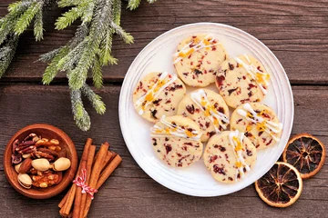 Fototapete Zu Essen Christmas holiday cranberry orange icebox cookies. Top down view table scene on a dark wood background.  © Jenifoto
