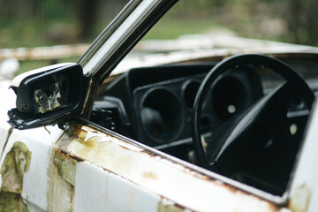 Steering Wheel Inside an Abandoned Broken White Car
