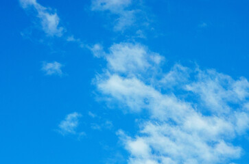 Vibrant blue sky with fluffy white clouds on a beautiful sunny day