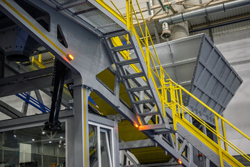 Modern industrial machinery at a mobile concrete plant, showcasing sturdy metal structures, yellow safety railings, and essential production equipment. Perfect for construction and engineering themes.