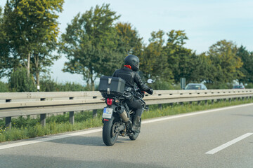 Riding a motorcycle on a scenic road with trees in the background during a clear day
