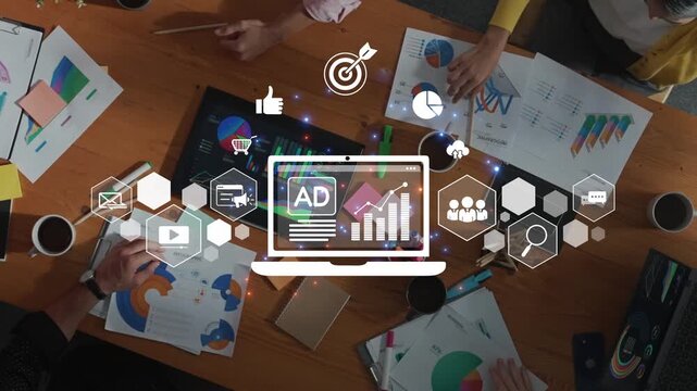 A vibrant overhead view of a team collaborating in a modern office space, surrounded by laptops, papers, and charts, reflecting dynamic discussion and creative progress. Raster