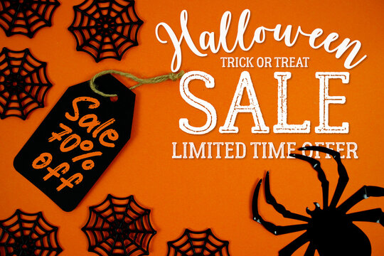 Halloween Sale 70% on orange background featuring a black gift tag, spider webs, and a creepy spider for Halloween-themed labels, party invites, or seasonal promotions.