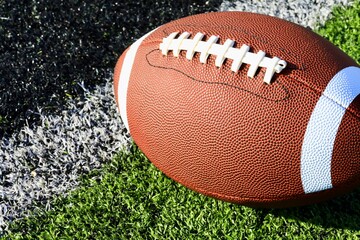 Close up of an American football on the sports field 