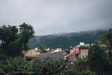 view on a city in a foggy tropical forest
