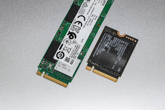 Close up NVME PCIe solid-state drive in the M.2 2230 and 2280 form factor isolated on metal background.