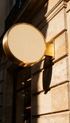 Golden round signboard on modern building facade
