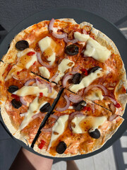 Healthy lavash pizza with cheese, olives and vegetables