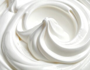 Close-up of freshly whipped cream, showing a swirl and smooth texture