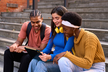 Diverse students studying together using digital tablet