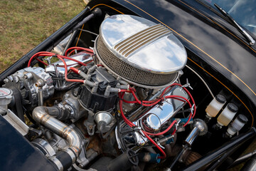 Fototapeta premium Classic Car Engine with Red Wiring and Chrome Details