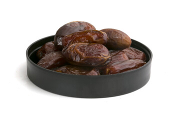 dried dates on a black plate