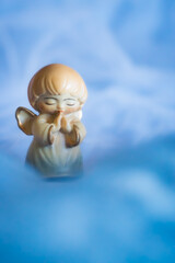 Guardian angel - wooden angel on a blue background	