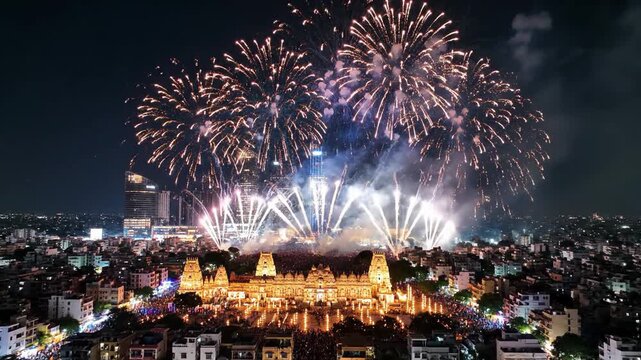 Vibrant Hindu temple celebration with spectacular fireworks over a modern Indian city cityscape video footage.