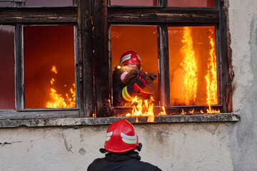 Firefighters battling flames in burning building, risking lives, firemen extinguishing blaze,...