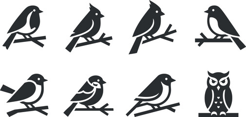 A collection of silhouettes of various birds perched on branches including an owl.