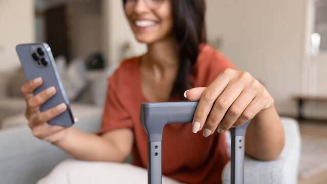 Happy Latin tourist woman using airlines application for online check-in