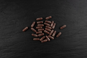 Iron capsule, Fe pills, dark red hemoglobin supplement tablets, vitamin capsules, mineral