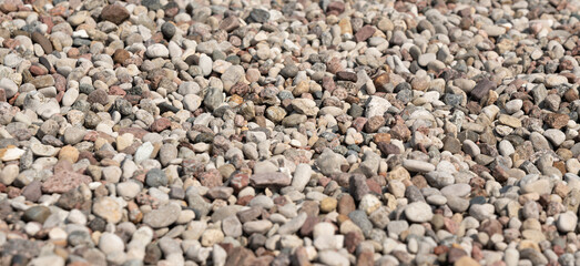 Pebble stones textured background. Small round rocks pattern top view, smooth pebble
