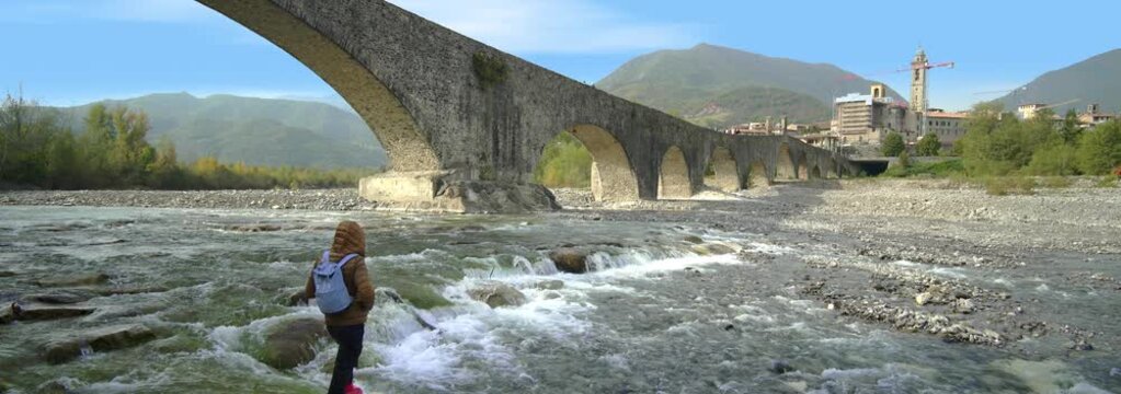 Anamorphic Lens - Boy admires the Devil's Bridge in Bobbio, Italy