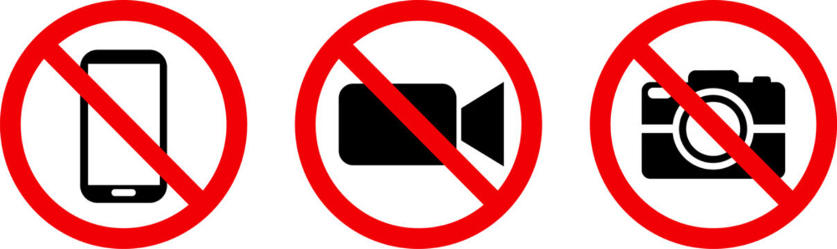 set of signs prohibiting electronic devices, including a smartphone, a video camera, and a still camera within red circles, Rules prohibit taking photographs or filming in public spaces
