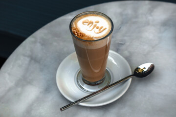 Close-up of latte coffee in a transparent cup with 