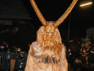 Noetsch, Austria - December 09, 2023: Krampuslauf Noetsch festival features a horned creature in...