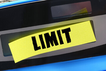 LIMIT word on a small yellow sheet of paper placed on a calculator.