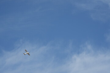 An airplane that flies in the blue sky
