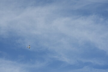 An airplane that flies in the blue sky