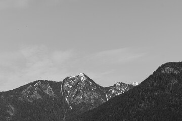 black and white mountain peaks with snow-capped peaks and bright blue skies