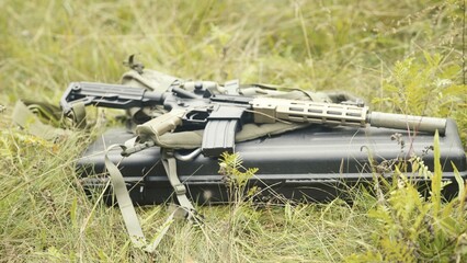 AR-15 or MK4 carbine with full equipment lying on the grass