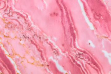 Pink marble texture close-up. Surface natural marble with various shades of pink and white color veins, background, closeup, high resolution.