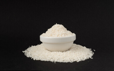 Grated coconut powder. Dry coco flakes pile, shredded desiccated coconut, tropical fruit chips