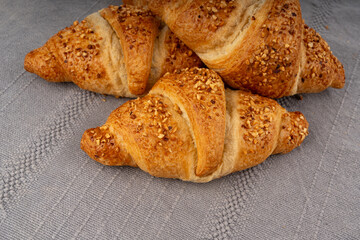 Delicious croissant with nut crumbs, sweet French bakery