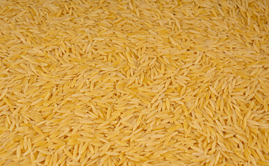 Raw orzo pasta, risoni or kritharaki pile