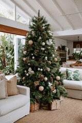 Festive Christmas tree decorated with ornaments in a cozy living room setting
