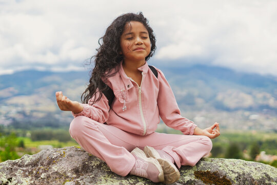 Girl meditating outdoors finding inner peace and balance. Children's Week