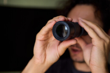 A Person Diligently Using a Telescope for Detailed Observation of the Night Sky and Beyond