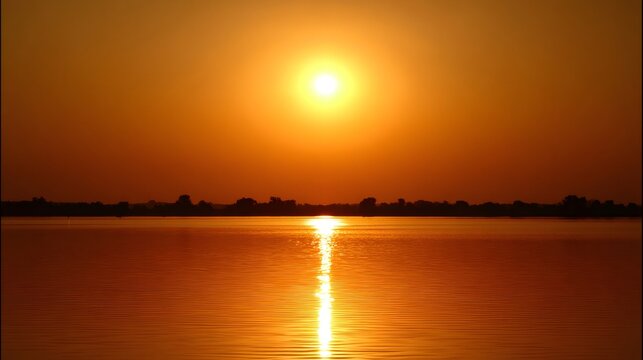 Golden sun creating a warm sunset over calm lake water with a reflection, feeling peaceful and serene with silhouette landscapes