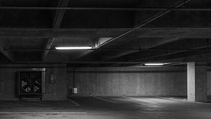 Black and white abstract of empty parking garage with fan