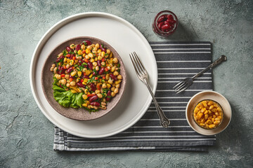 Colorful bean salad on plate with corn and kidney beans.