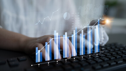 A businessman types on a laptop with an overlay of digital graphs and statistics to explore investment opportunities and technology-driven analysis in a modern office. Scalp